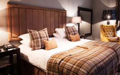 Luxury hotel bedroom decorated with Scottish flair, featuring a King sized bed.